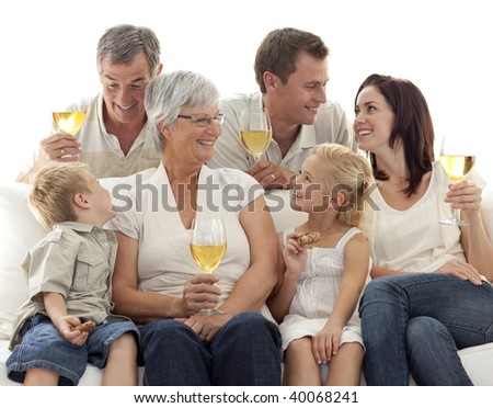 Family drinking wine and children eating biscuits at home