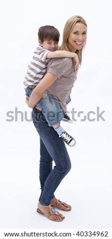 Mother giving son piggy back ride against white background