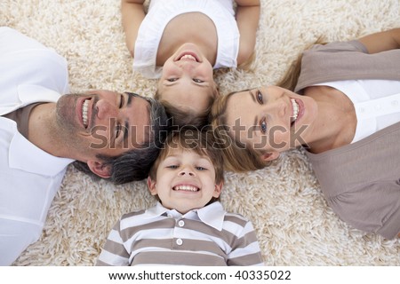 Smiling family lying on floor with heads together