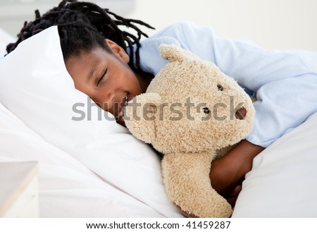 Young Boy in Hospital  hugging his teddy bear