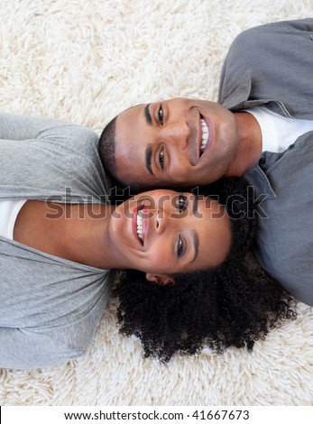stock photo : Smiling Afro-American couple lying on the floor at home