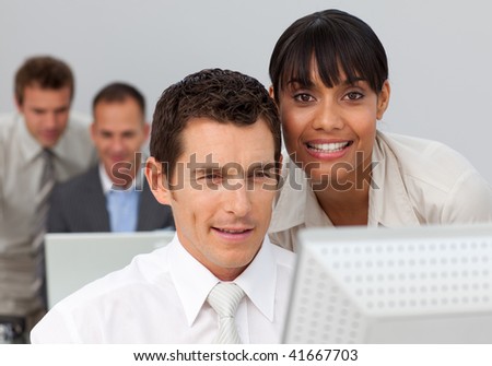 Afro-American businesswoman working with her colleague with a computer in the office