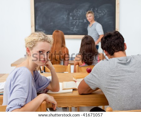 Group of teenagers studying together in a class