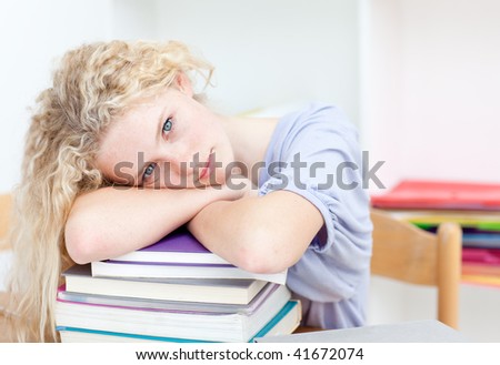 Blond teeenager sleeping in a library after studying long time