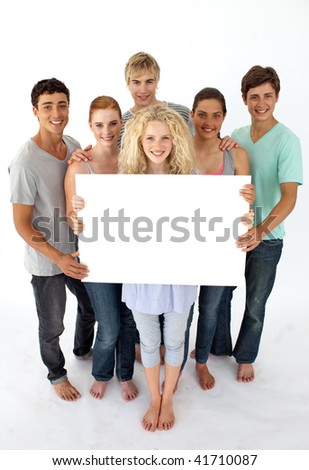 stock photo Group of teenagers holding a blank card agaisnt white 