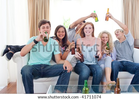 Young friends drinking beer at home
