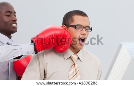 Boxing a young businessman in the office