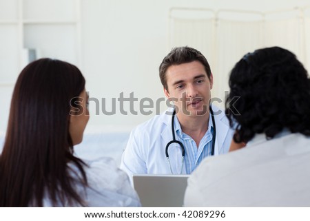 Male doctor explaining diagnosis to a couple during a visit