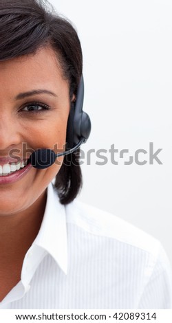 Ethnic customer service agent with headset on against white background