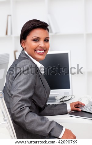 Attractive female executive  working at a computer in the office
