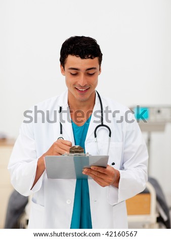 Young male Doctor holding a clip board and smiling