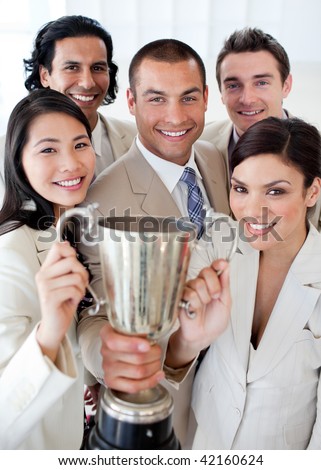 A successful business team holding a trophy. Concept of success.