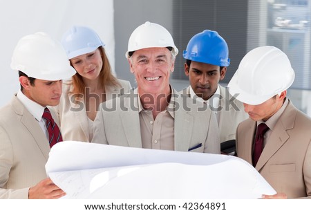 International engineer co-workers discussing a project in a building