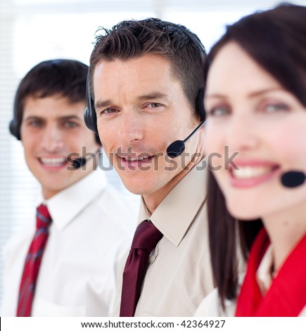 Customer service agents with headsets on in a call center