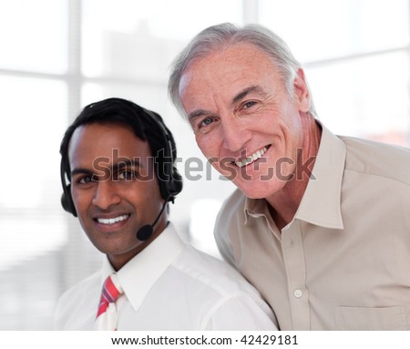 Senior businessman helping his colleague in the office