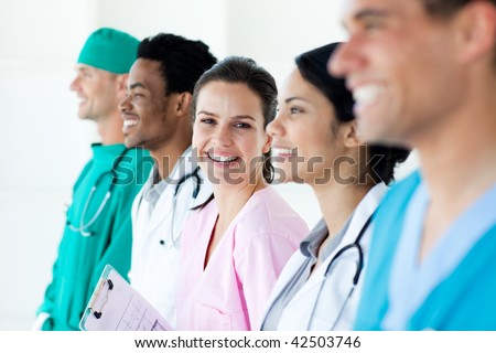International medical team standing in a line isolated on a white background