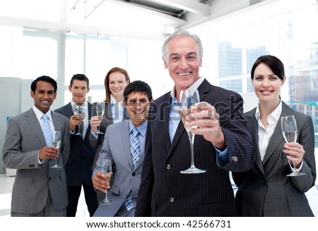 Happy diverse business group toasting with Champagne to celebrate a succes