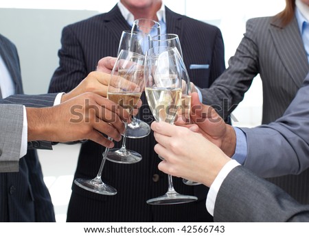 Close-up of business team toasting with Champagne in the office