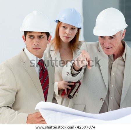 Engineers studying blueprints in a building site
