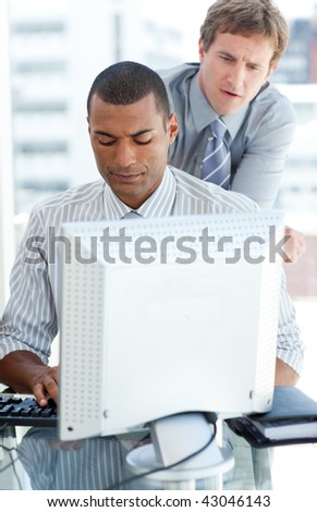 Concentrated businessmen at a computer in the office