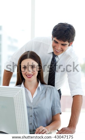 Attractive Co-workers at a computer in the office