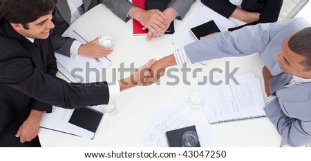 Close-up of successful business people closing a deal in a meeting