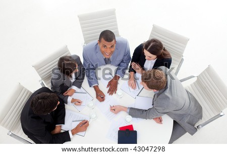 High angle of a business group sitting around a conference in a meeting