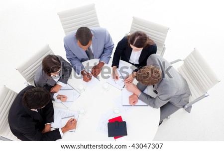 High angle of a diverse business group sitting around a conference table in a meeting