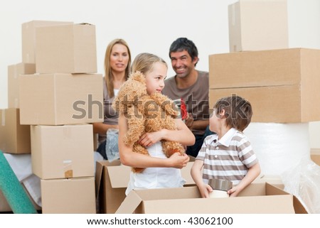 Young family unpacking boxes after move in