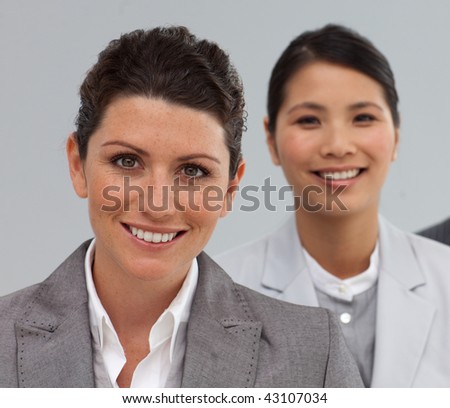 Attractive Business people standing in a line smiling at the camera