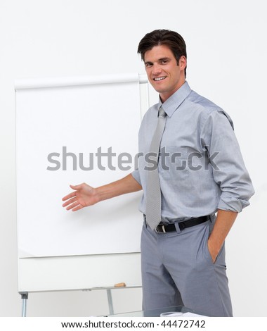 Self-assured businessman pointing at a board at a presentation