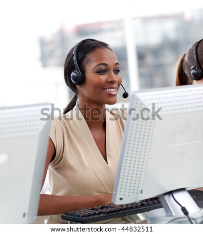 Female customer service agent with headset on in a call center