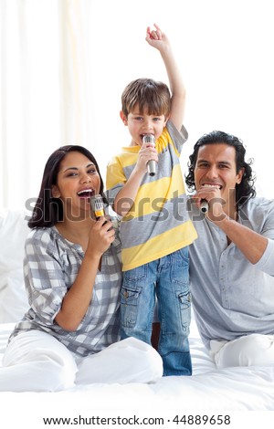 Animated family singing with microphones on a bed