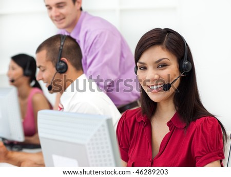 Positive Customer service representative using headset in the office