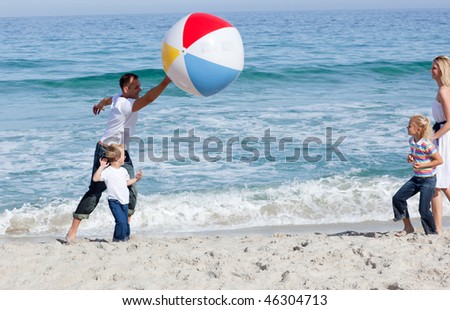 Animated family playing with a ball at the beach