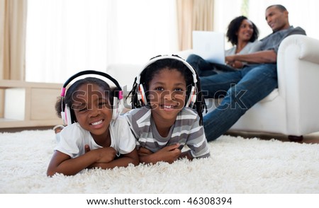 Cute siblings listening music in the living room