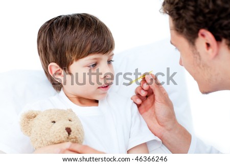 Caucasian doctor taking little boy\'s temperature at the hospital