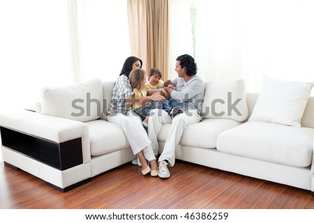 Animated family having fun sitting on sofa at home