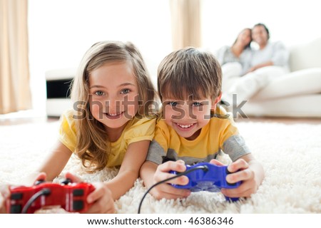 Loving siblings playing video game in the living room