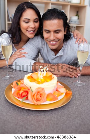 Charming man and his wife celebrating his birthday in the kitchen