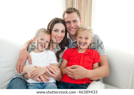 Portrait of Happy family sitting on sofa in the living room