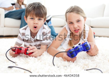 Animated children playing video games lying on the floor