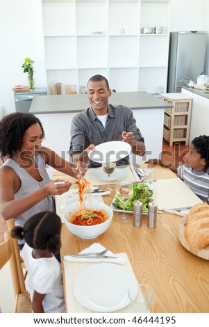 Afro-american family dining together in the kitchen