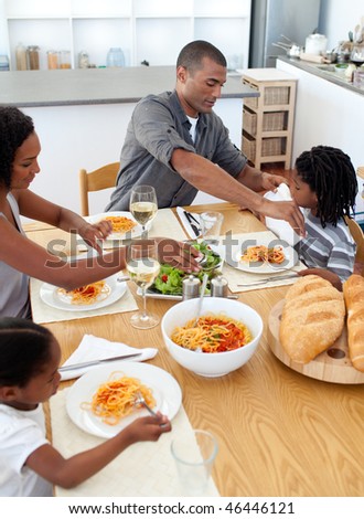 Cheerful family dining together in the kitchen