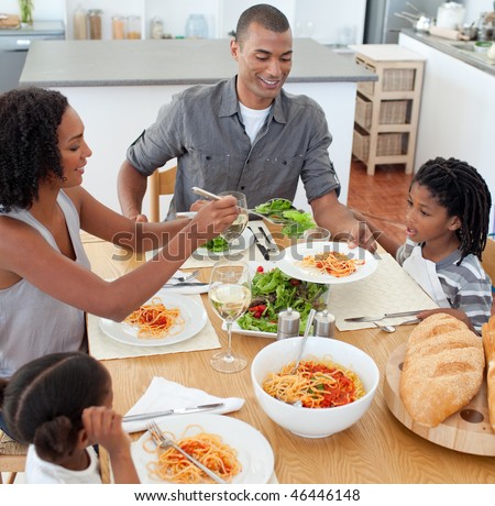 Jolly family dining together in the kitchen