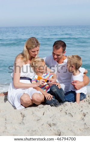 Caring mother with her family holding sunscreen at the beach