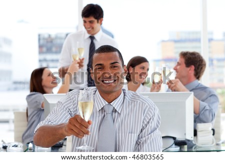 Confident business team drinking champagne in the office