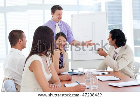 Charming businessman doing a presentation to his team