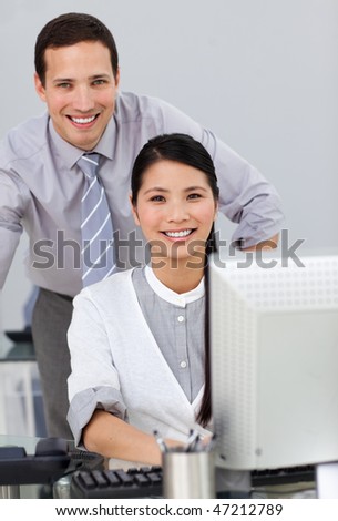 Attractive businesswoman helping by her manager in the office