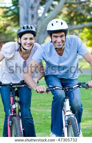 Animated couple riding a bike in a park
